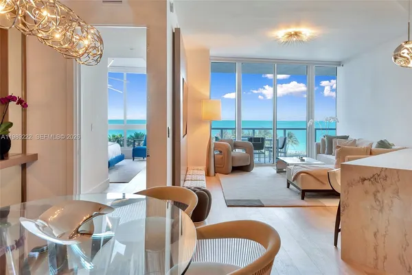 a living room with furniture and a chandelier