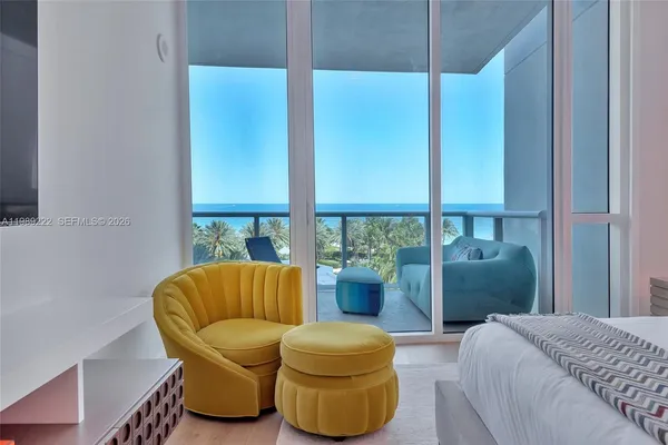 a living room with a couch and a potted plant