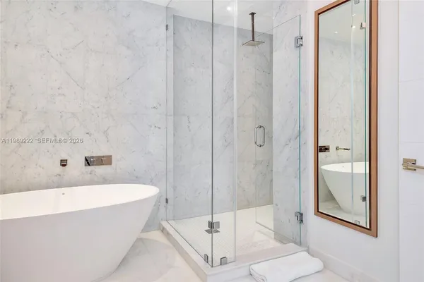 a bathroom with a tub and shower