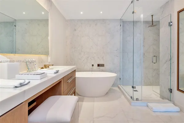 a bathroom with a tub a sink and a shower