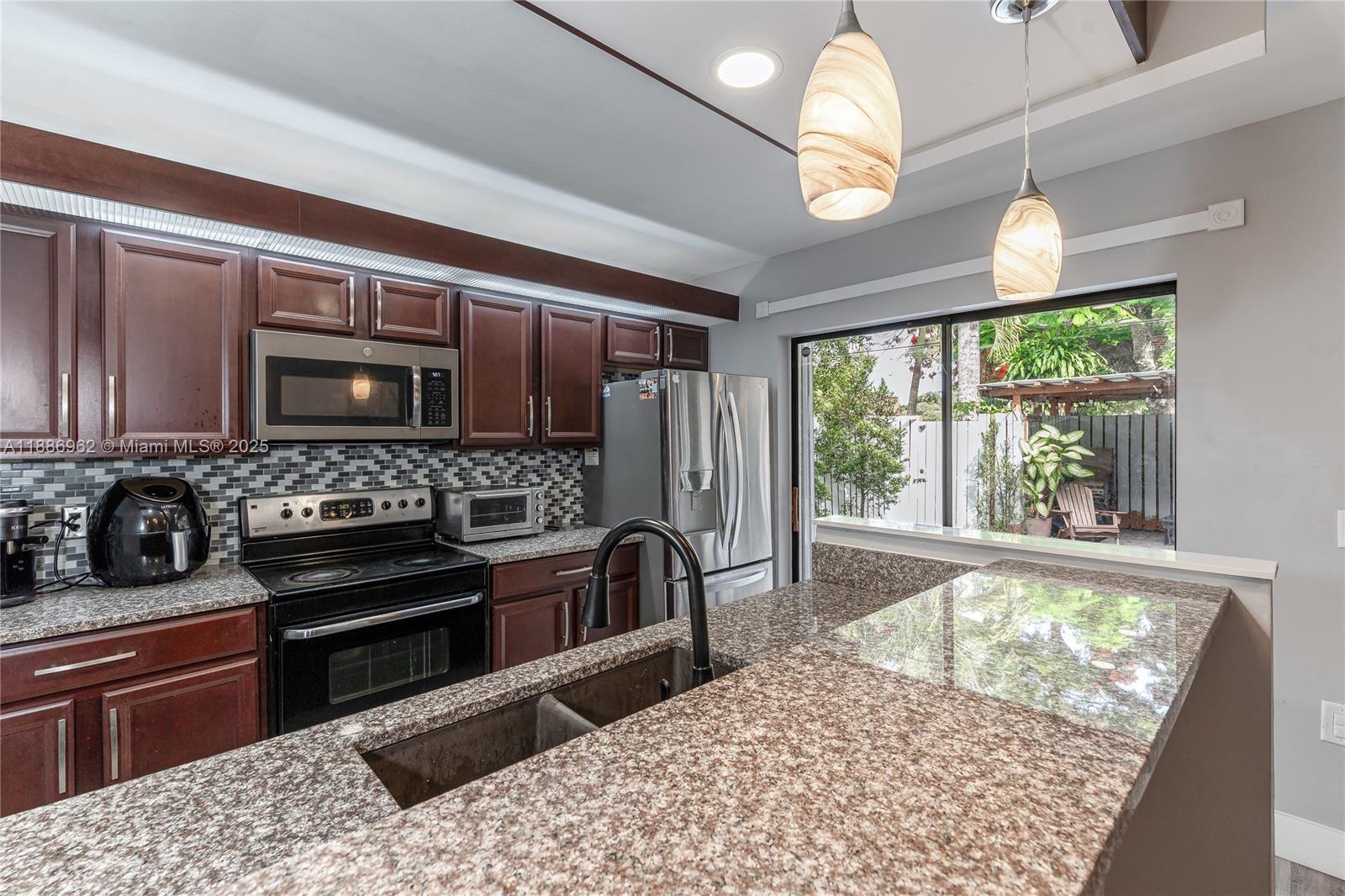 a kitchen with a stove a sink and a refrigerator