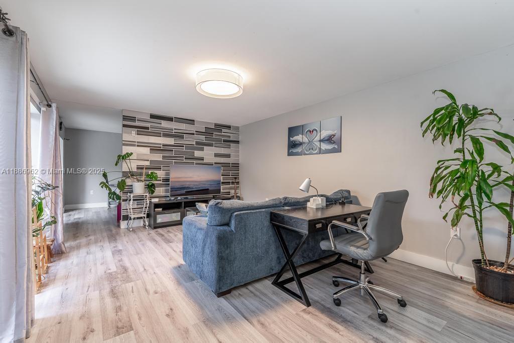 9146 Southwest 23rd Street Davie, FL 33324 - Photo 14 of 21 a workspace with furniture window and wooden floor