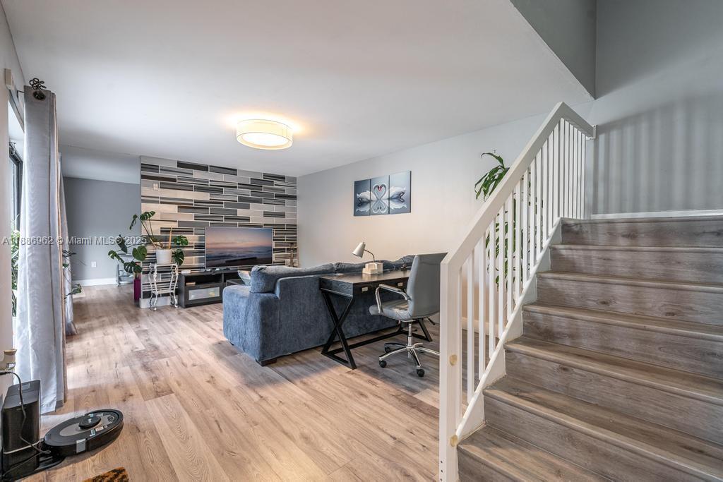 9146 Southwest 23rd Street Davie, FL 33324 - Photo 16 of 21 a living room with furniture and a wooden floor