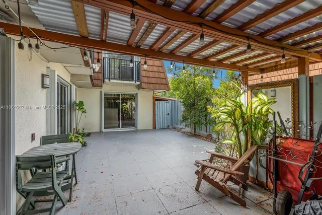 a view of an chairs and table in the patio