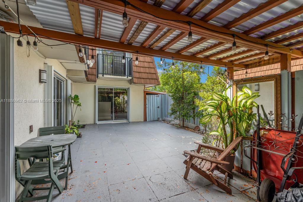 9146 Southwest 23rd Street Davie, FL 33324 - Photo 20 of 21 a view of an chairs and table in the patio