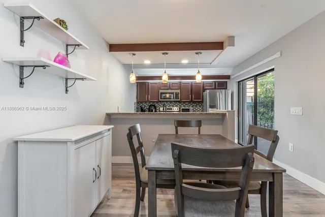 a dining room with kitchen island a table and chairs