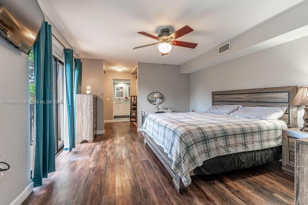 9146 Southwest 23rd Street Davie, FL 33324 - Photo 7 of 21 a bedroom with a large bed and a chandelier