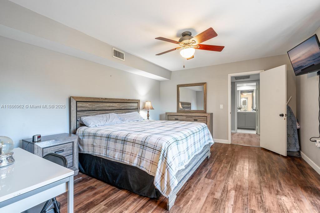 9146 Southwest 23rd Street Davie, FL 33324 - Photo 8 of 21 a bedroom with a bed and wooden floor