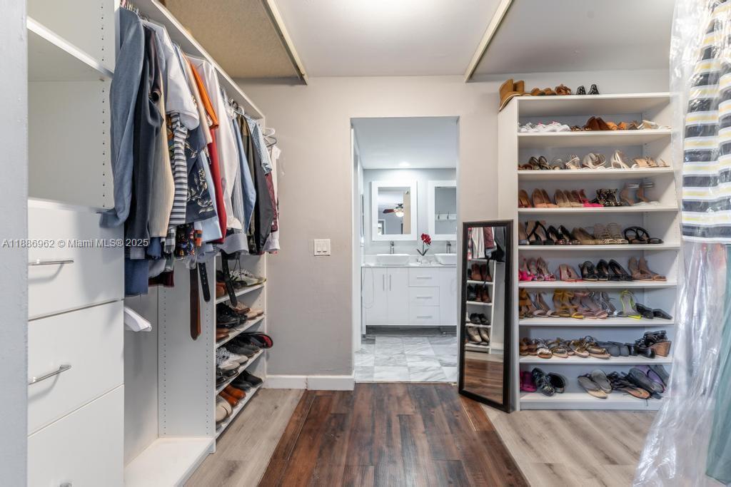 9146 Southwest 23rd Street Davie, FL 33324 - Photo 9 of 21 a view of walk in closet with clothes and shoes