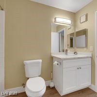 698 South Racetrack Road, Unit 412 Henderson, NV 89015 - Photo 25 of 25 Bathroom featuring toilet, wood finished floors, vanity, and baseboards