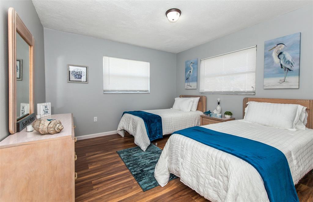 140 Columbia Road Venice, FL 34293 - Photo 15 of 30 a bedroom with two beds and painting on the wall