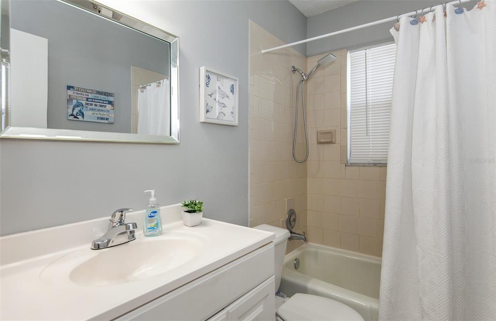 140 Columbia Road Venice, FL 34293 - Photo 16 of 30 a bathroom with a sink a mirror a shower and a bathtub