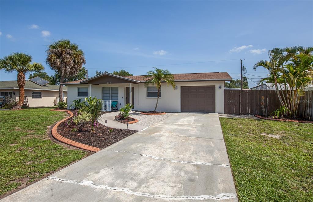 140 Columbia Road Venice, FL 34293 - Photo 2 of 30 a front view of a house with a yard and garage