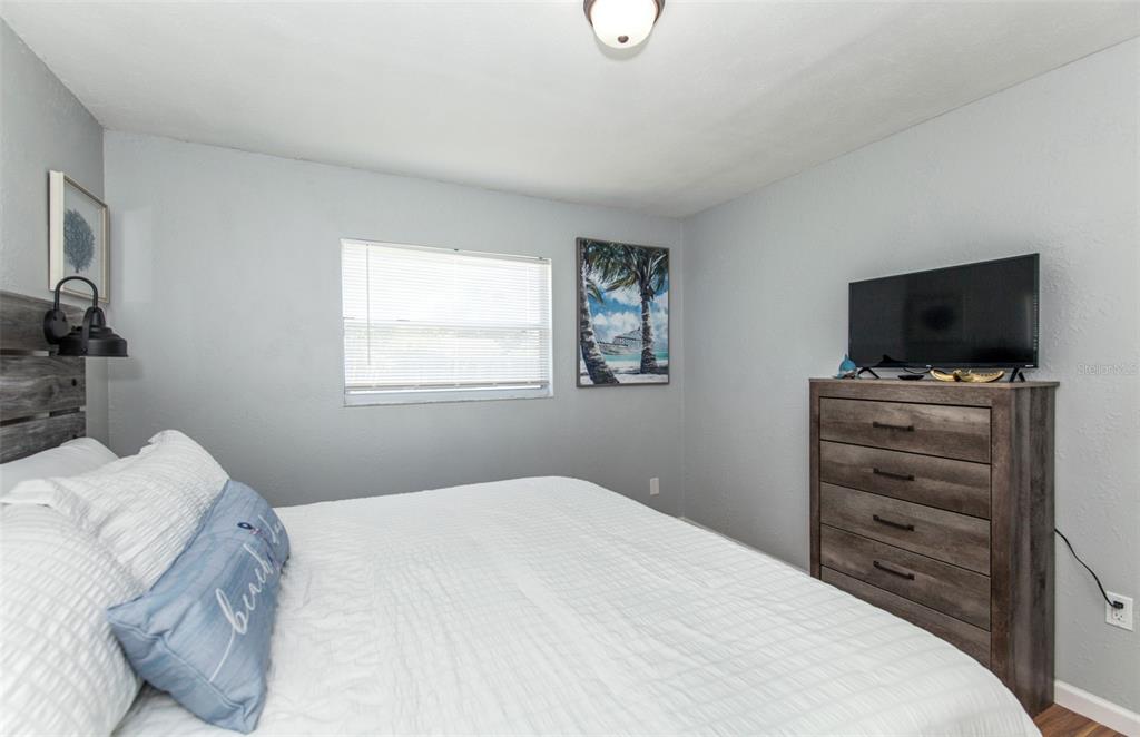 140 Columbia Road Venice, FL 34293 - Photo 23 of 30 a bedroom with a bed and a flat screen tv