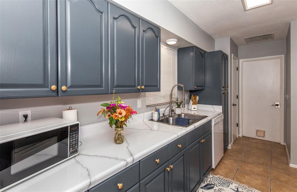 140 Columbia Road Venice, FL 34293 - Photo 3 of 30 a kitchen with a sink and cabinets