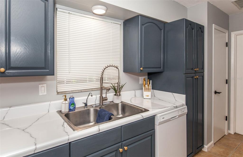 140 Columbia Road Venice, FL 34293 - Photo 4 of 30 a kitchen with a sink cabinets and a window