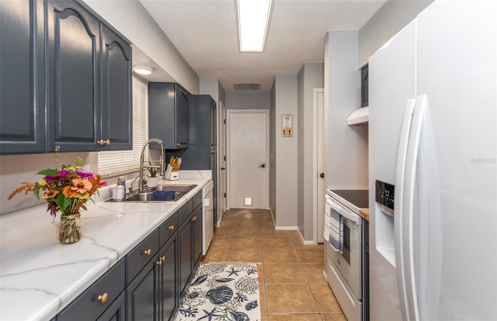 140 Columbia Road Venice, FL 34293 - Photo 5 of 30 a kitchen with stainless steel appliances granite countertop a sink stove and refrigerator