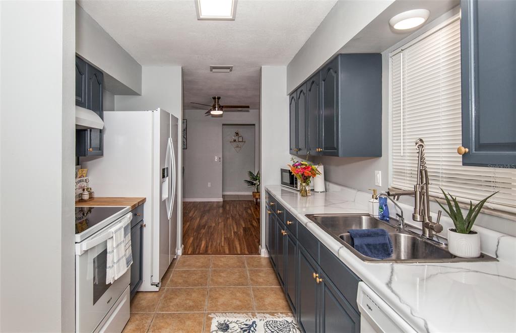 140 Columbia Road Venice, FL 34293 - Photo 6 of 30 a kitchen with a sink stove and refrigerator
