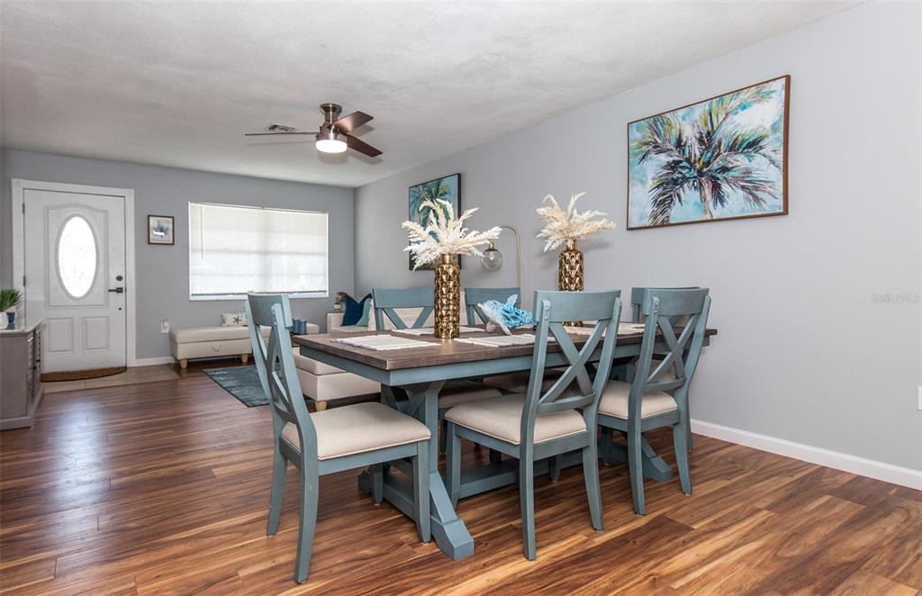 140 Columbia Road Venice, FL 34293 - Photo 8 of 30 a view of a dining room with furniture and wooden floor