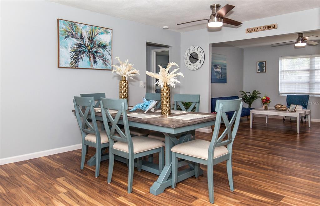 140 Columbia Road Venice, FL 34293 - Photo 9 of 30 a dining room with furniture and wooden floor