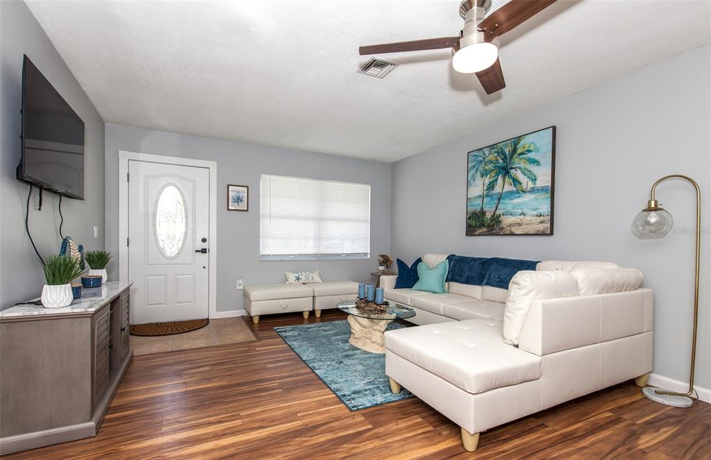 140 Columbia Road Venice, FL 34293 - Photo 10 of 30 a living room with furniture a flat screen tv and a window