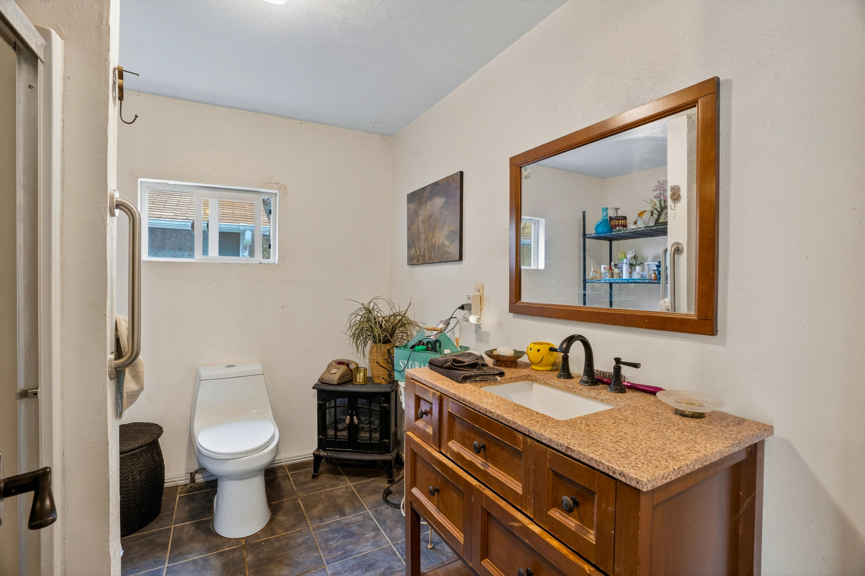 16937 Stagecoach Road Corning, CA 96021 - Photo 9 of 24 a bathroom with a granite countertop sink a toilet and a mirror