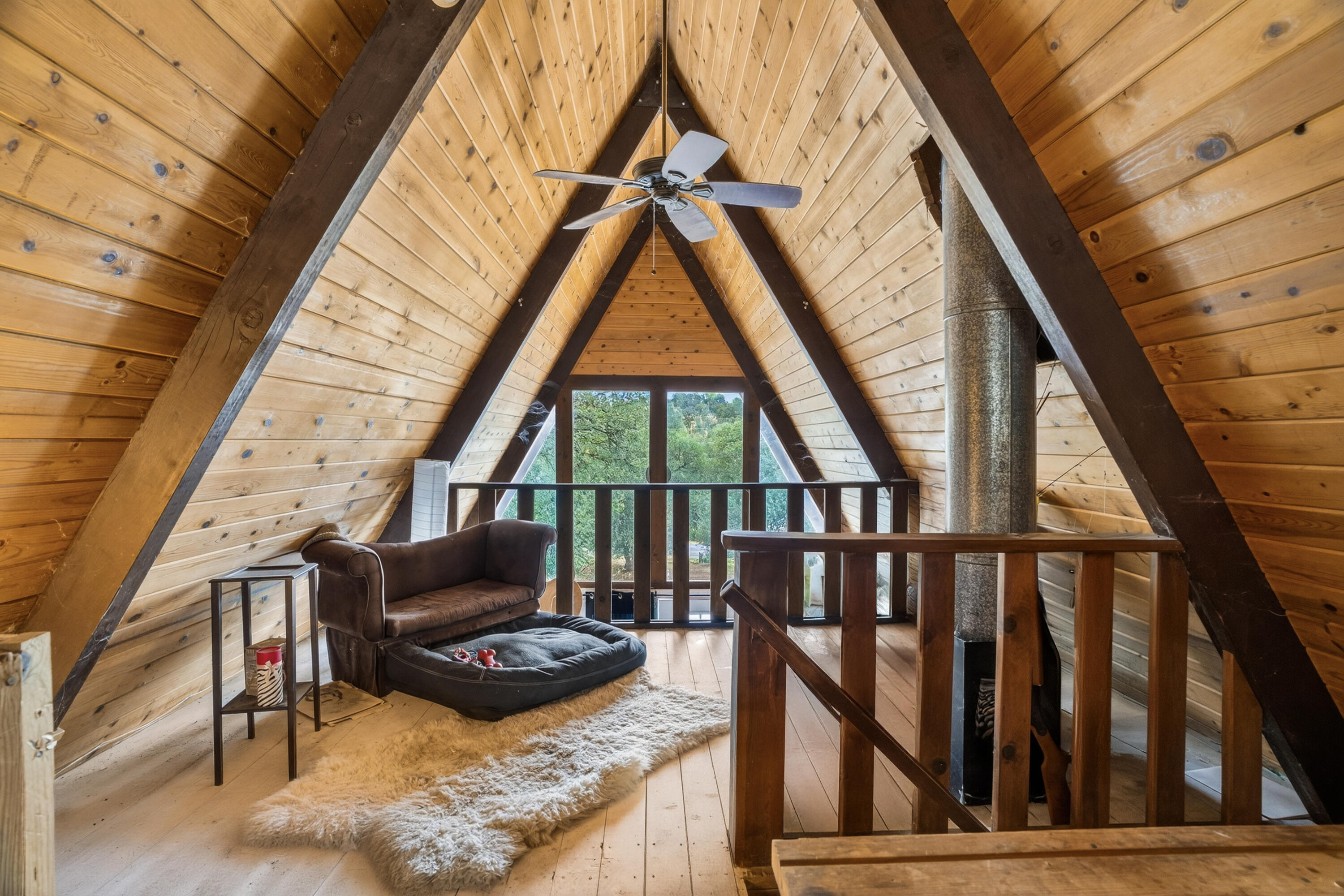 16937 Stagecoach Road Corning, CA 96021 - Photo 10 of 24 a living room with furniture and a floor to ceiling window