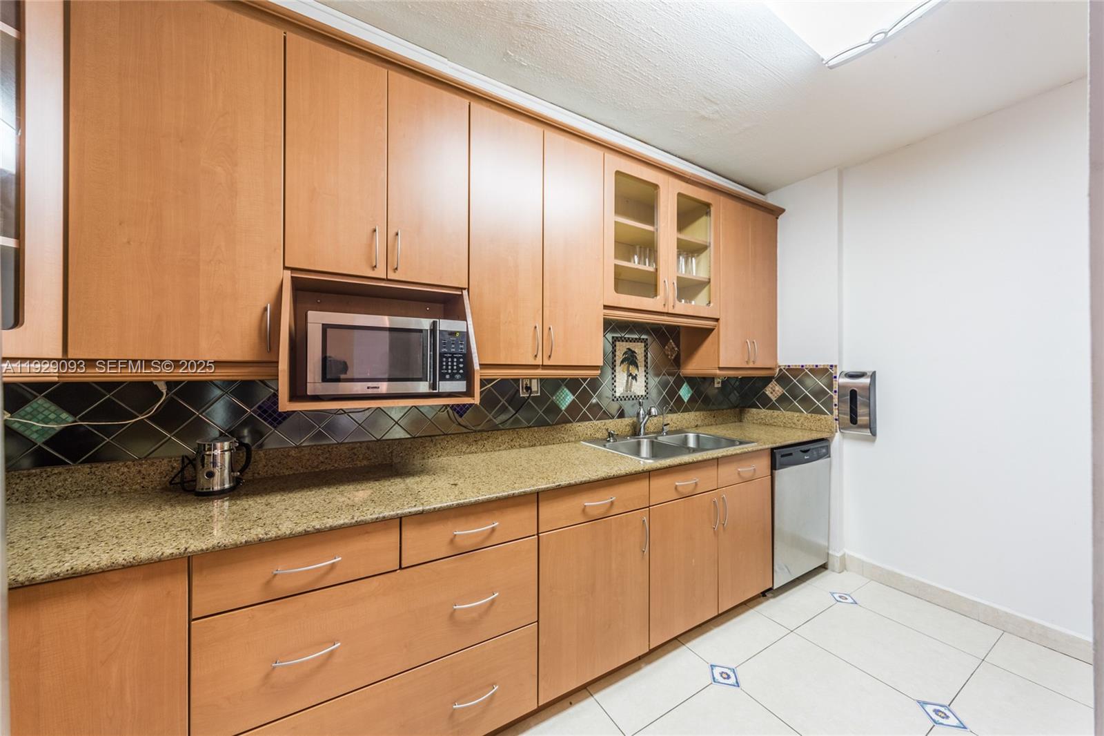 121 Crandon Boulevard, Unit 248 Key Biscayne, FL 33149 - Photo 11 of 37 a kitchen with stainless steel appliances granite countertop a sink and a cabinets