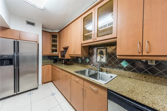 a kitchen that has a sink and a granite counter tops