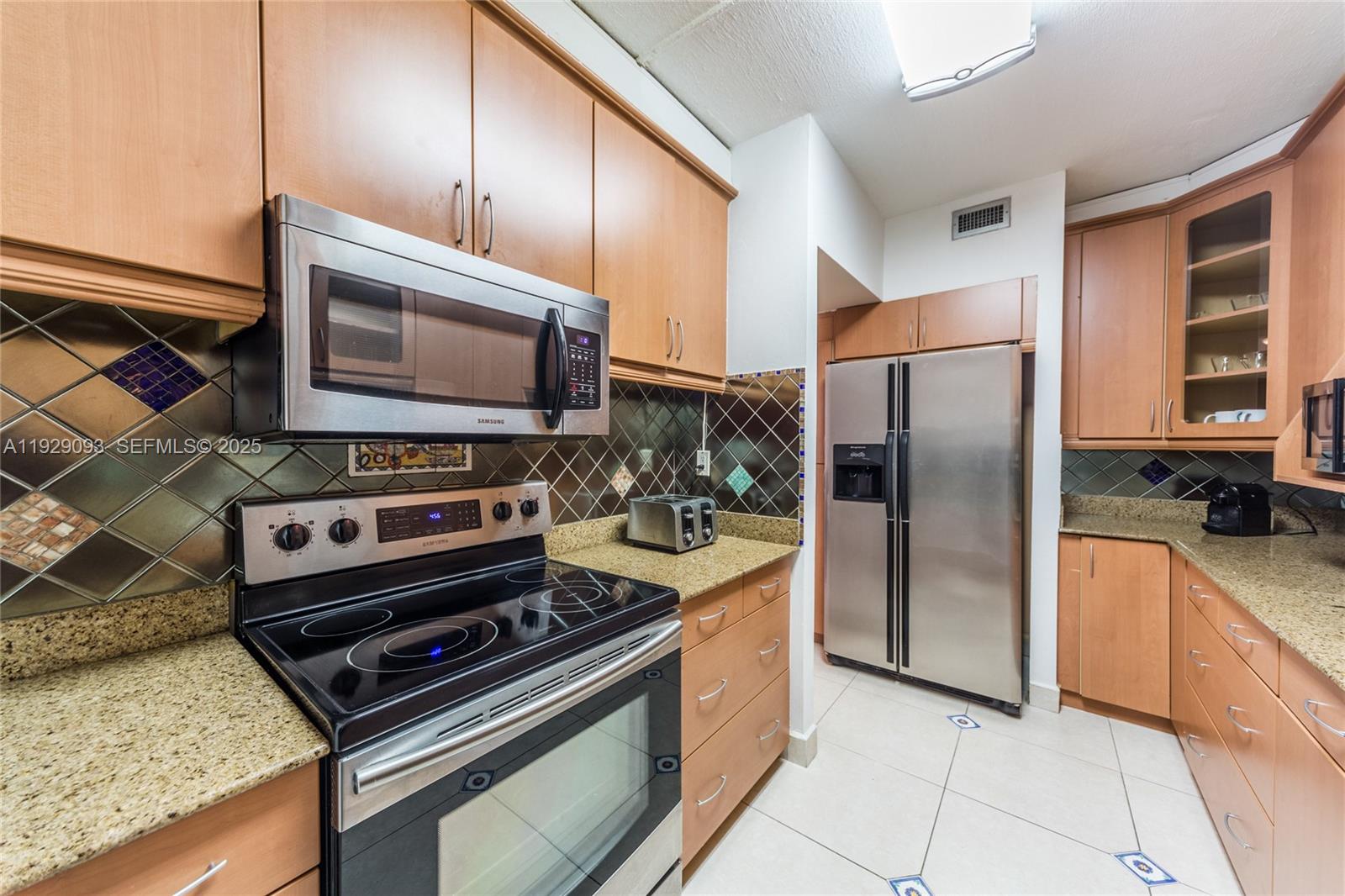 121 Crandon Boulevard, Unit 248 Key Biscayne, FL 33149 - Photo 14 of 37 a kitchen with stainless steel appliances granite countertop a refrigerator and a stove