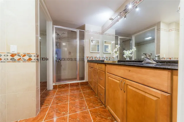 a bathroom with a mirror and a shower