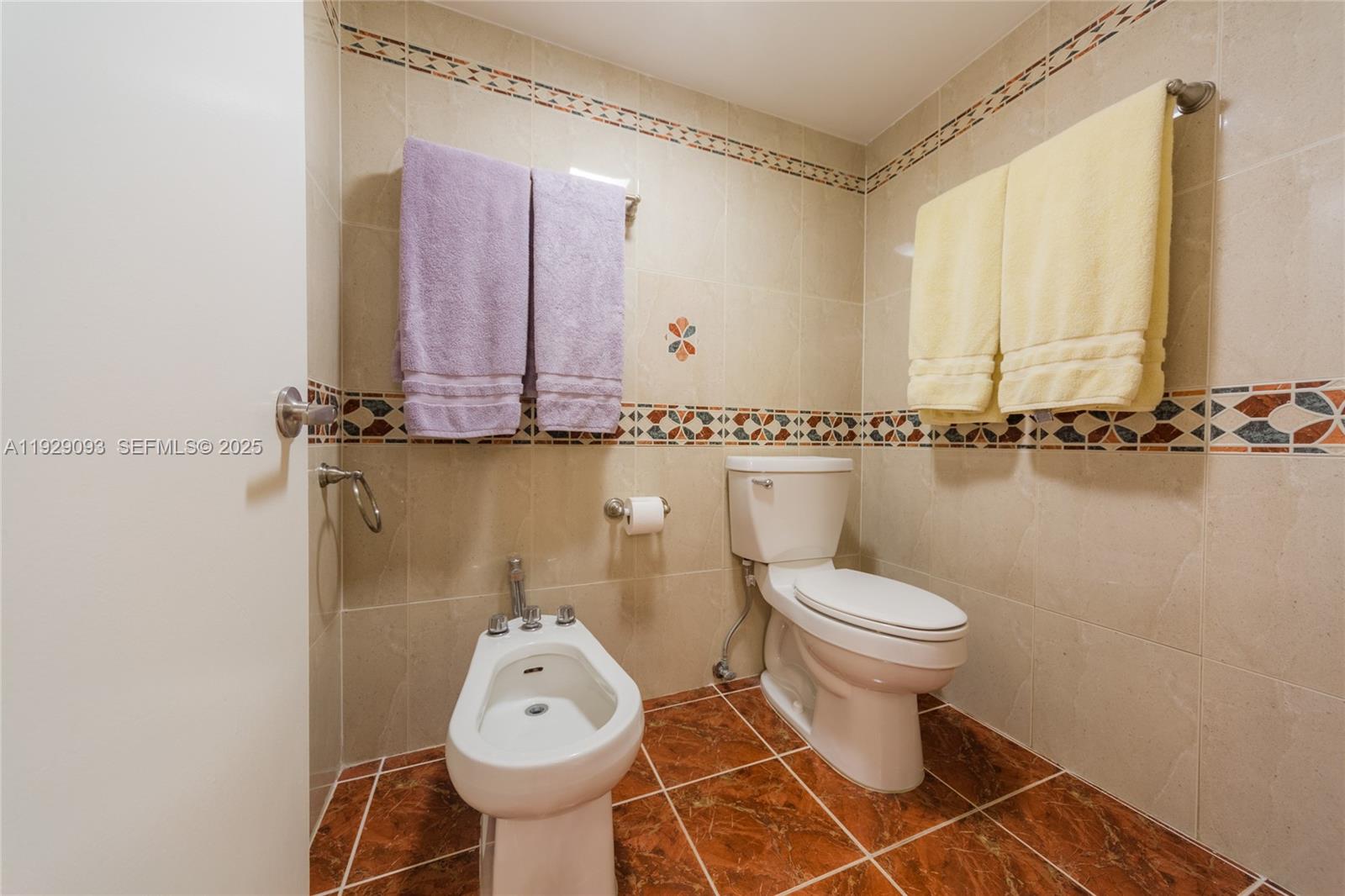 121 Crandon Boulevard, Unit 248 Key Biscayne, FL 33149 - Photo 19 of 37 a bathroom with a toilet sink and mirror