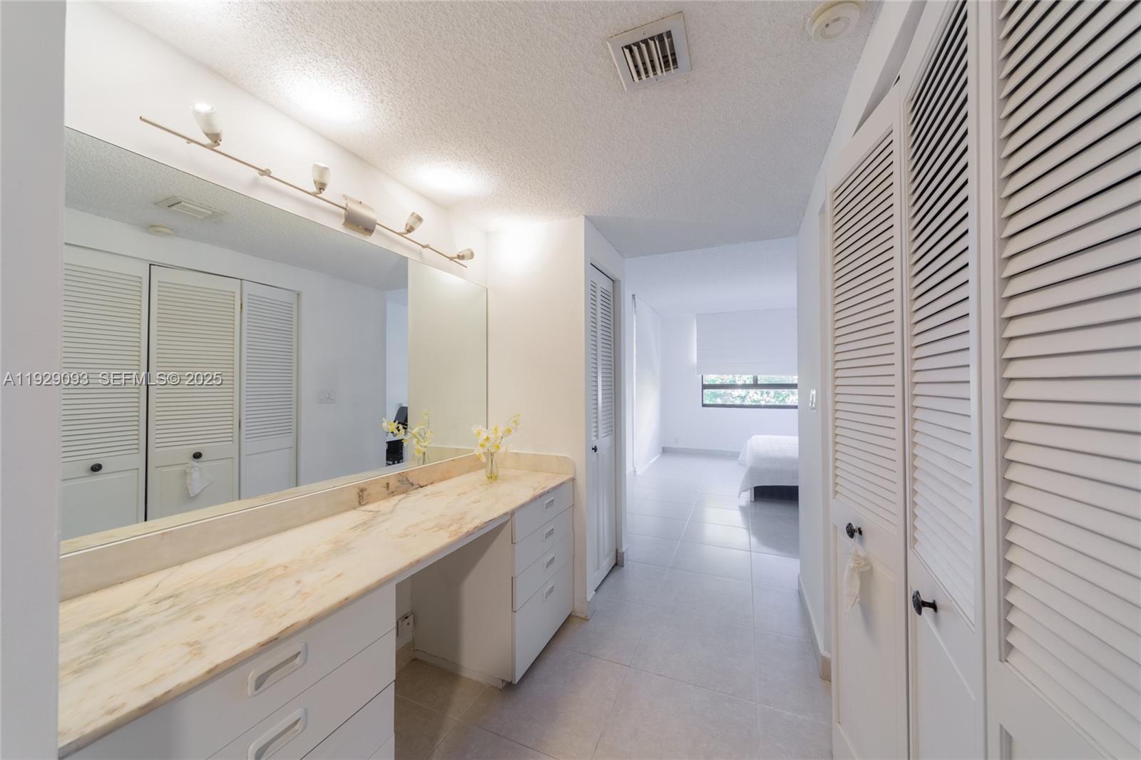 121 Crandon Boulevard, Unit 248 Key Biscayne, FL 33149 - Photo 22 of 37 a spacious bathroom with a granite countertop sink a toilet a shower and a mirror