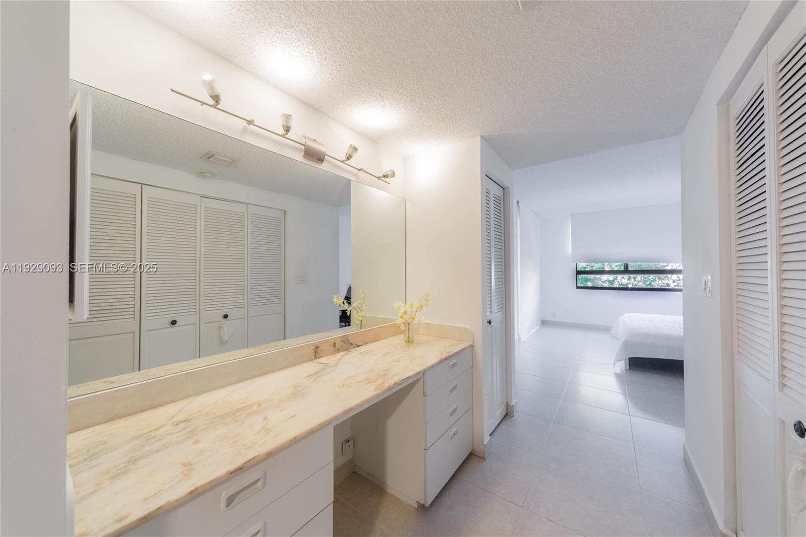 121 Crandon Boulevard, Unit 248 Key Biscayne, FL 33149 - Photo 23 of 37 a bathroom with a sink and a mirror