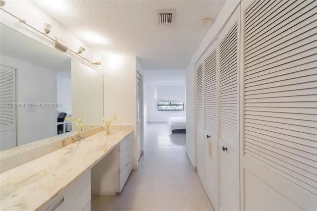 a spacious bathroom with a double vanity sink and a mirror
