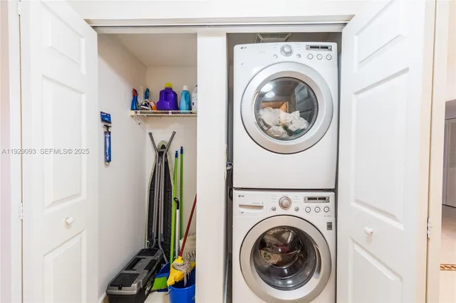 a view of a storage and utility room with dryer and washer
