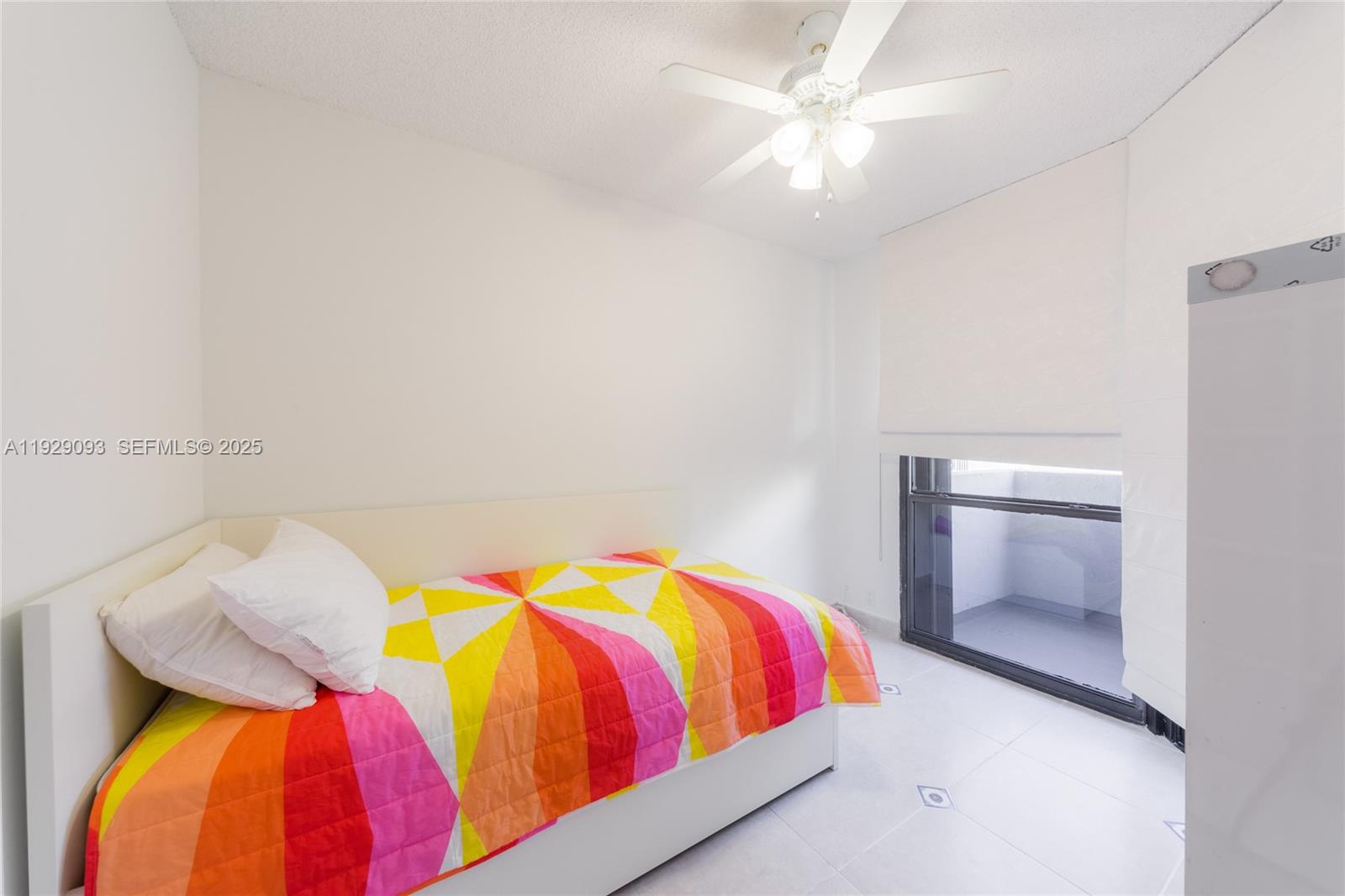 121 Crandon Boulevard, Unit 248 Key Biscayne, FL 33149 - Photo 29 of 37 a bedroom with a bed and a chandelier