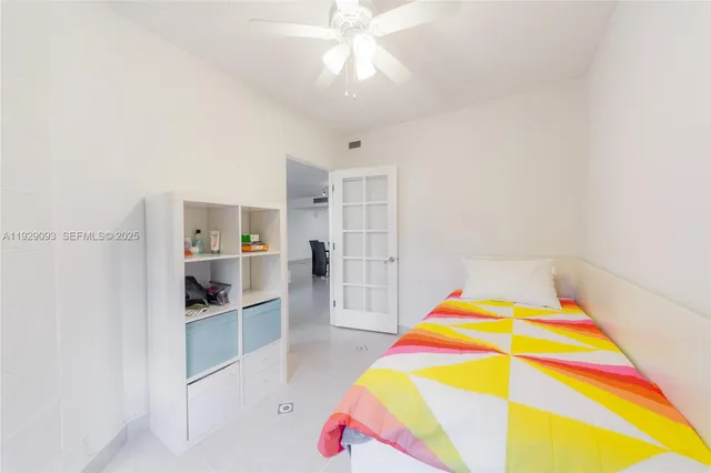 a room with kitchen island and stainless steel appliances