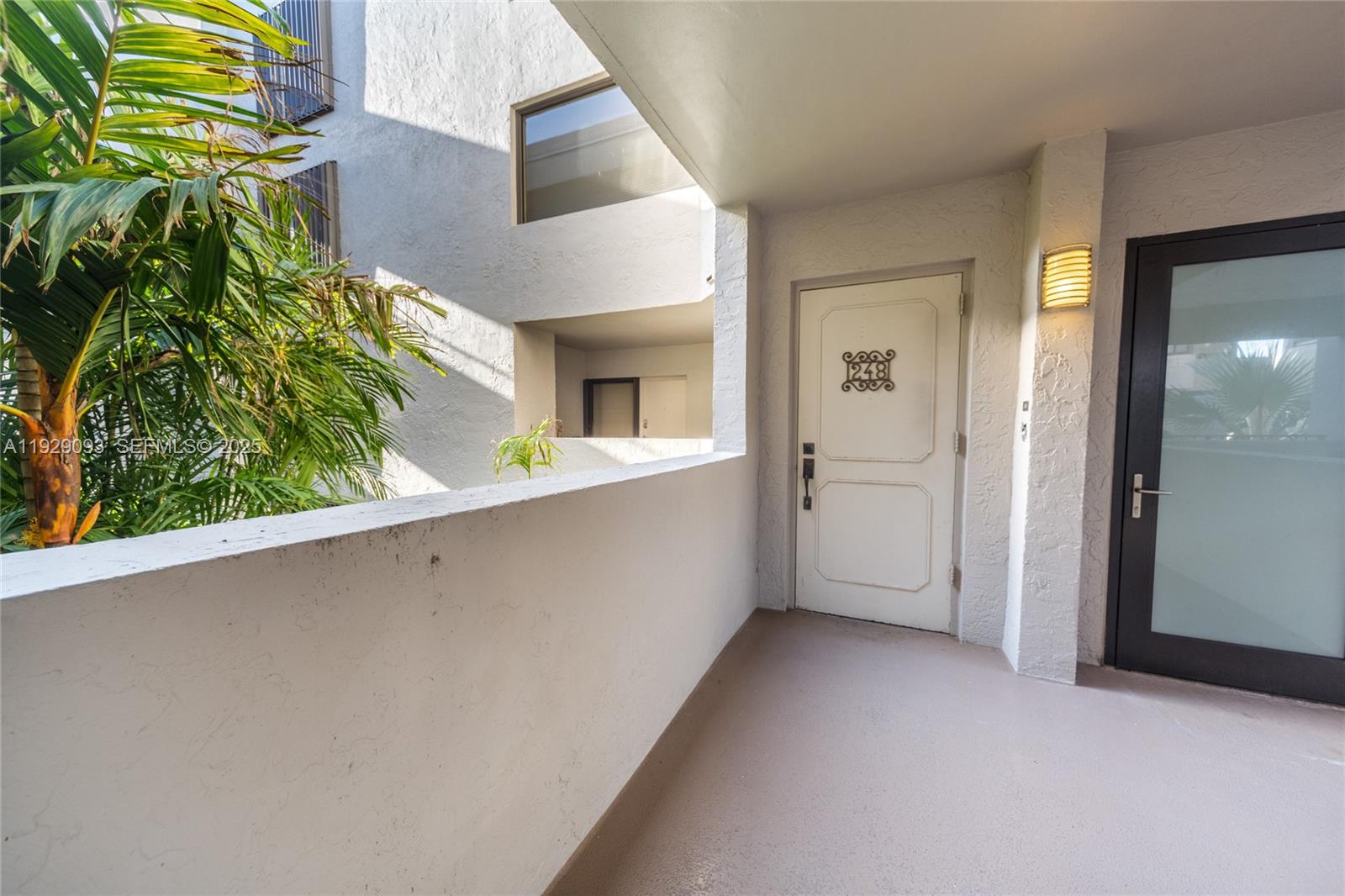 121 Crandon Boulevard, Unit 248 Key Biscayne, FL 33149 - Photo 33 of 37 a view of a hallway with plants