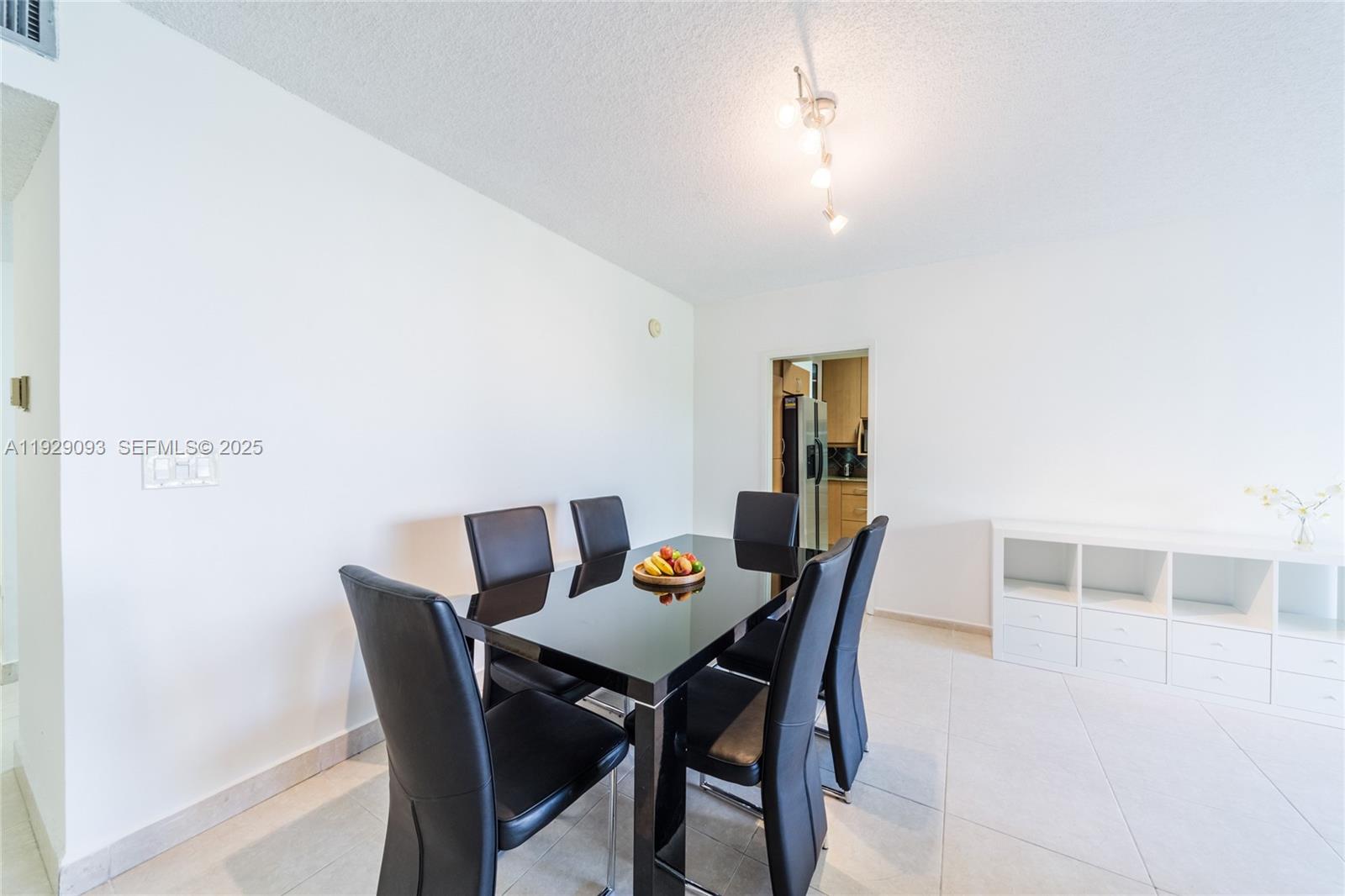 121 Crandon Boulevard, Unit 248 Key Biscayne, FL 33149 - Photo 6 of 37 a view of a dining room with furniture and wooden floor