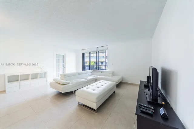 a living room with furniture and a floor to ceiling window