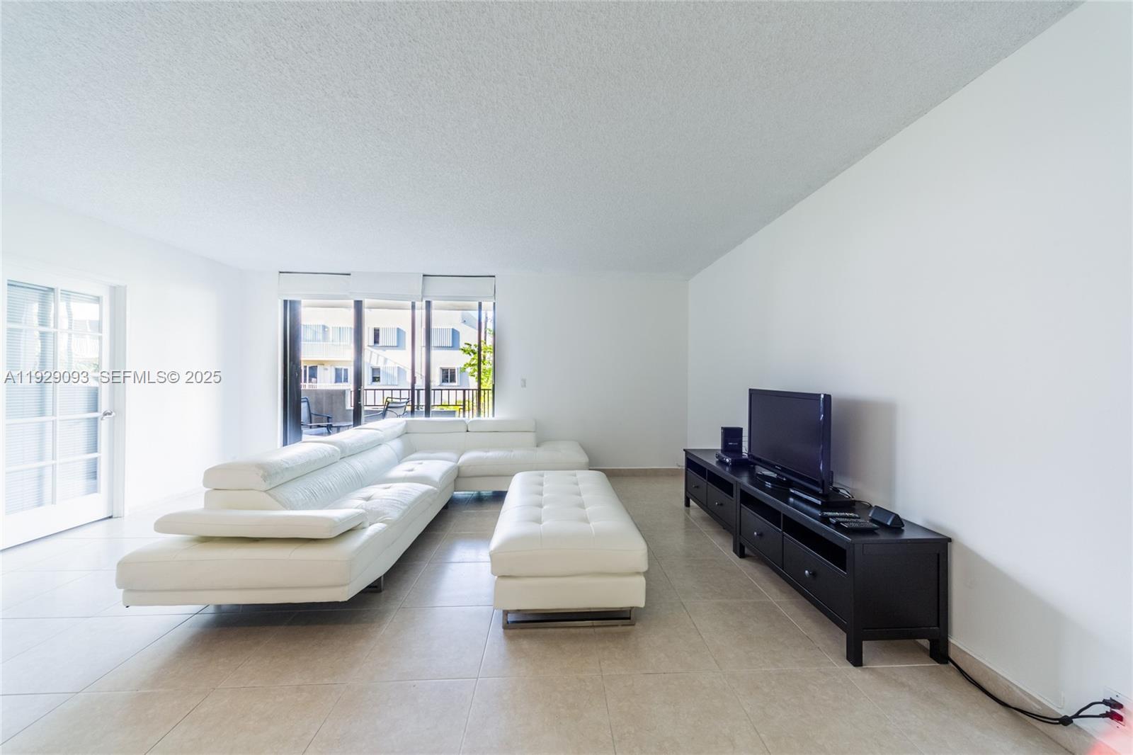 121 Crandon Boulevard, Unit 248 Key Biscayne, FL 33149 - Photo 8 of 37 a living room with furniture and a flat screen tv