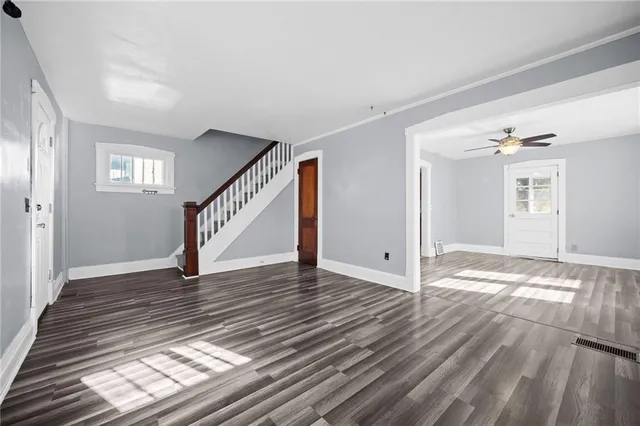 a view of empty room with wooden floor