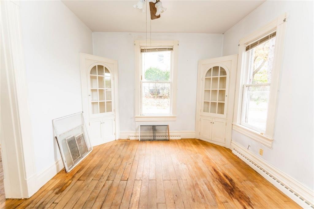 303 South 6th Street Indiana, PA 15701 - Photo 4 of 14 an empty room with wooden floor and windows