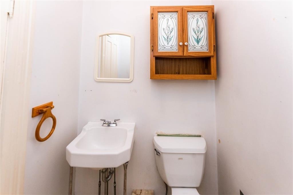 303 South 6th Street Indiana, PA 15701 - Photo 7 of 14 a bathroom with a toilet a sink and mirror