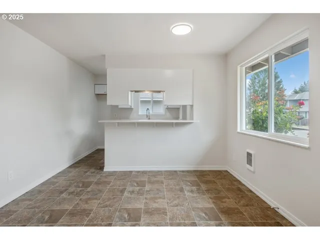 a kitchen with kitchen island and window