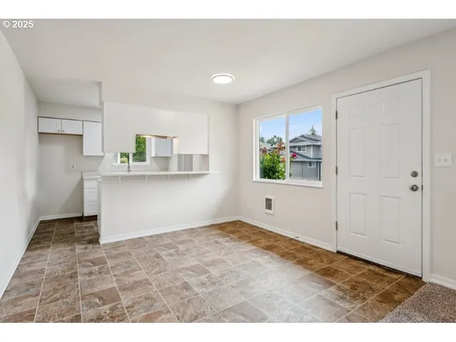 a kitchen with a sink cabinets and window