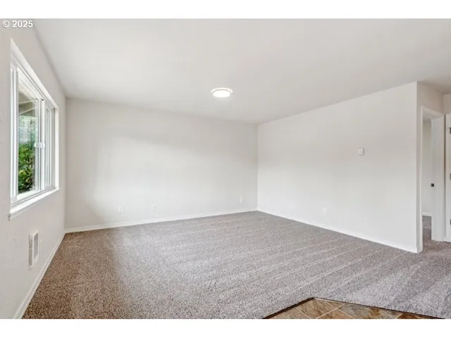 a view of wooden floor and windows in a room