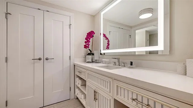 a bathroom with a sink toilet and mirror