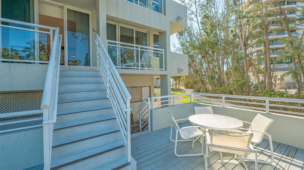 250 Sands Point Road, Unit 5101 Longboat Key, FL 34228 - Photo 22 of 42 a balcony with table and chairs